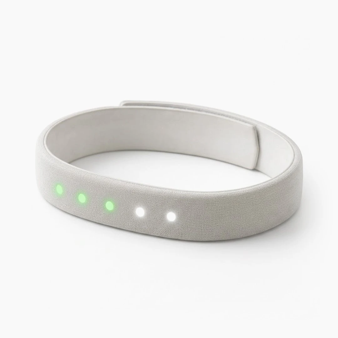 The Habit band from the side: soft grey fabric, three green lights and two white.
